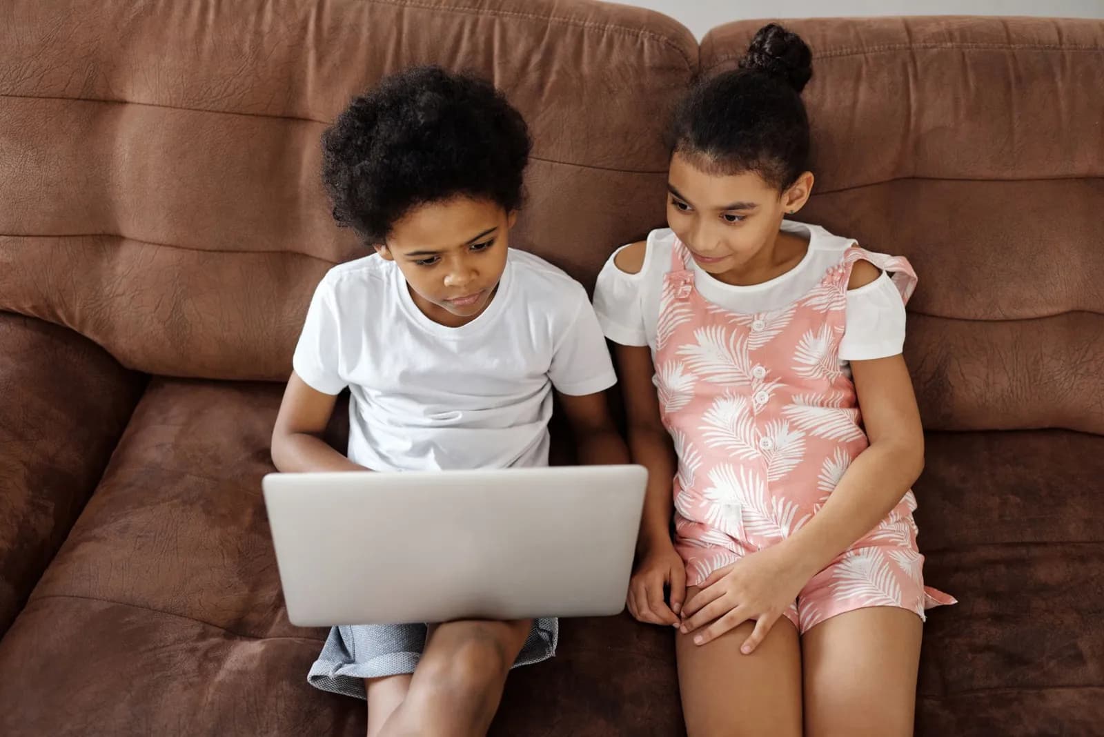 Two children exploring a project together on a laptop